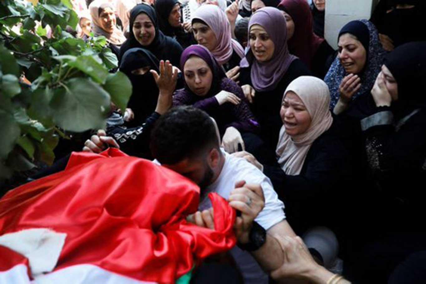 Palestinians bid farewell to mother killed in zionist forces raid